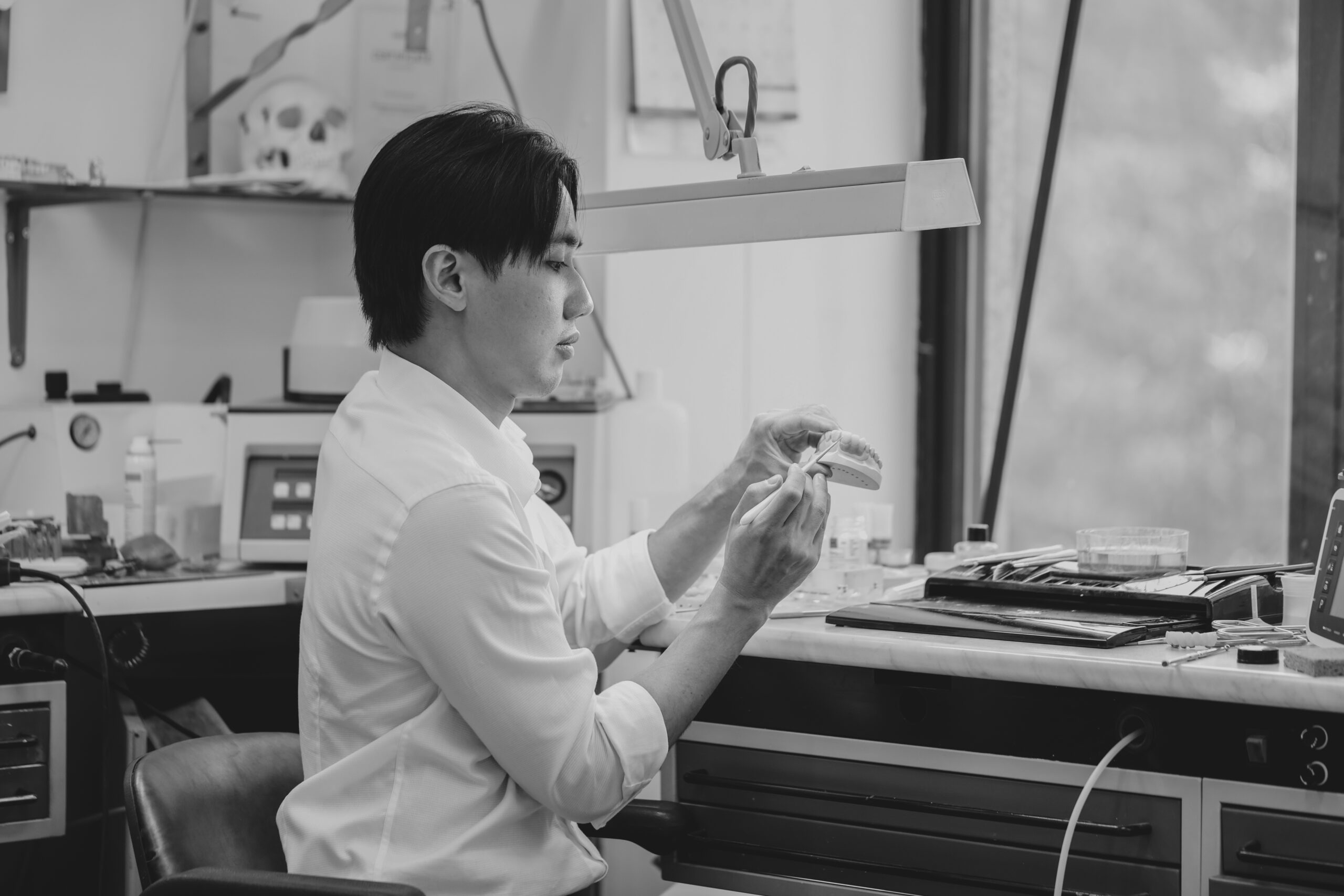 dr kent boon dentist hand-crafting porcelain veneers at kita dental, sydney